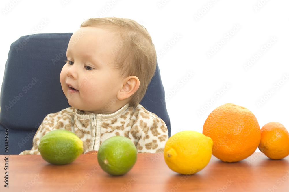 Baby and fresh fruits on table isolated background Baby and fresh fruits on table isolated background