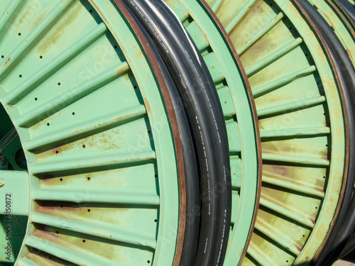 metal spools of wire in the yard of an electric utility company