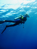 Scuba diver in clear blue water