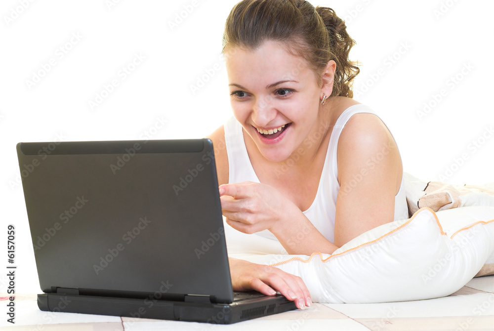 Surprised girl with laptop in her bed. Isolated. Surprised girl with laptop in her bed. Isolated.