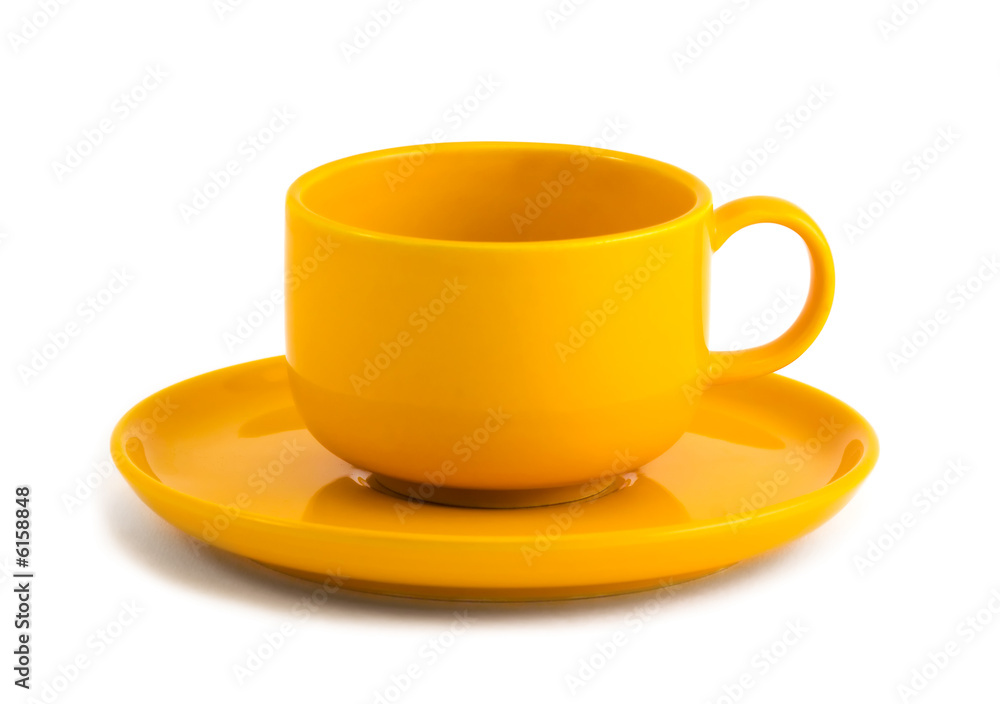 Simple yellow coffee cup and saucer on white background Simple yellow coffee cup and saucer on white background