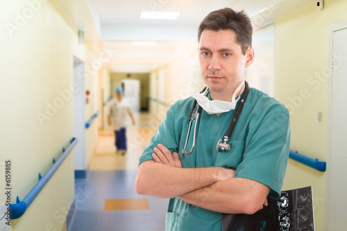 male doctor with tomogram in long corridor