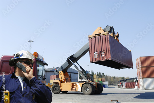 engineer and forklifts in container port photo