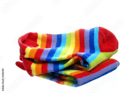 Rainbow coloured socks neatly folded and isolated on white