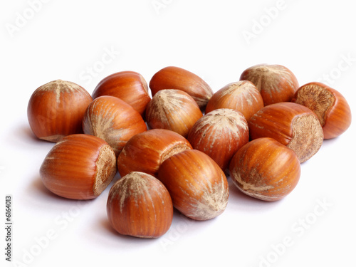 Handful of whole hazel nuts isolated on white