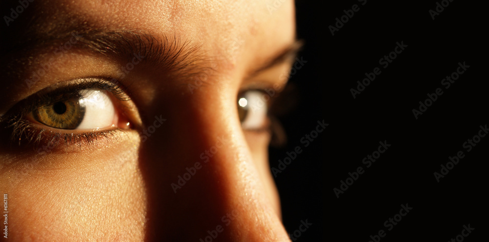 Obraz premium Low key image of 2 beautiful green eyes