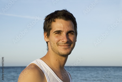 Smiling teen on the beach relaxing