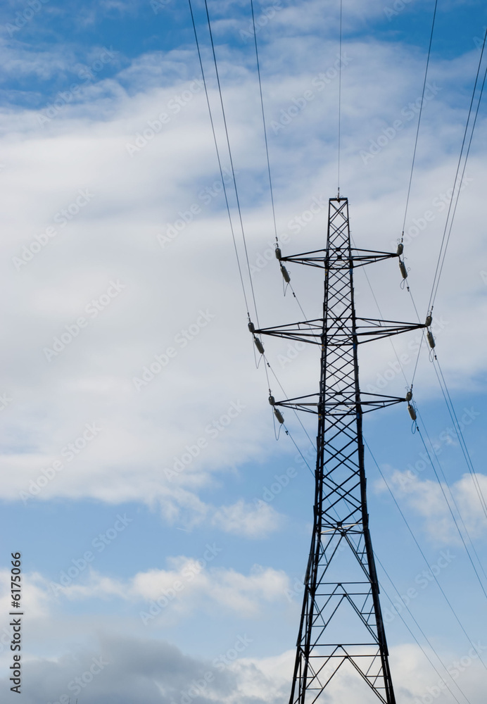 Electricity pylon against deep blue sky with white clouds Electricity pylon against deep blue sky with white clouds