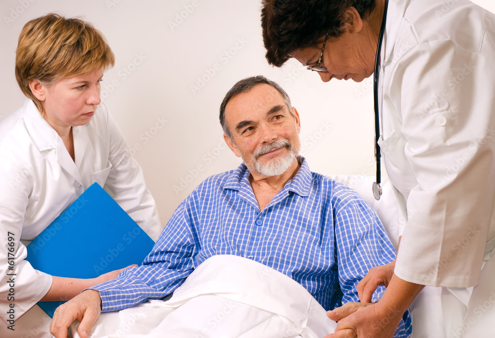 Fototapeta premium Two doctors with a patient