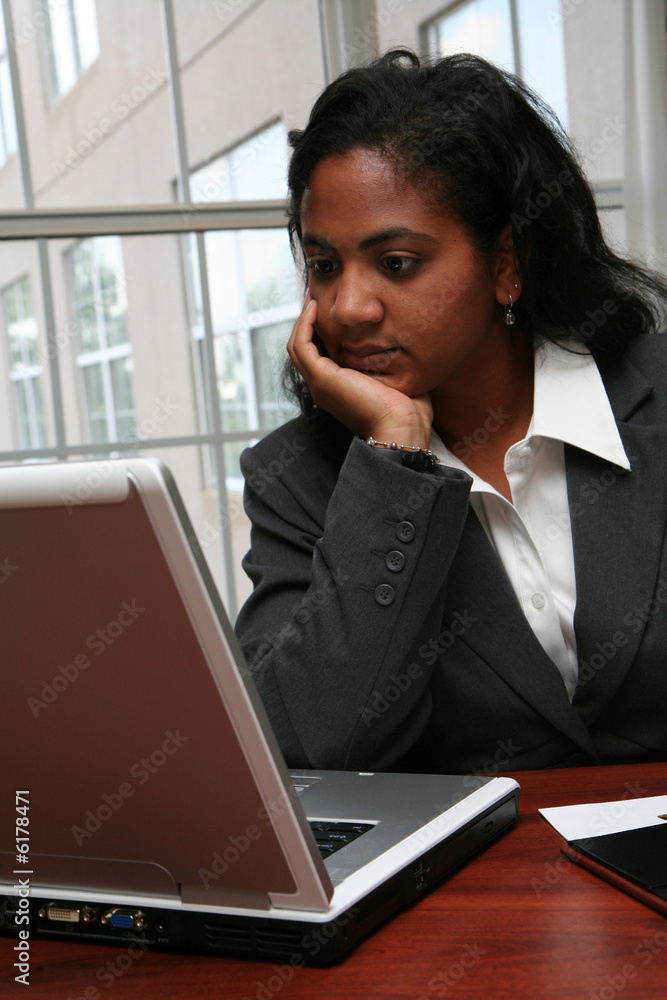 Businesswoman working on a computer in an office Businesswoman working on a computer in an office