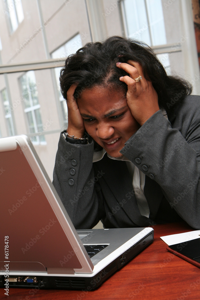 Businesswoman working on a computer in an office Businesswoman working on a computer in an office