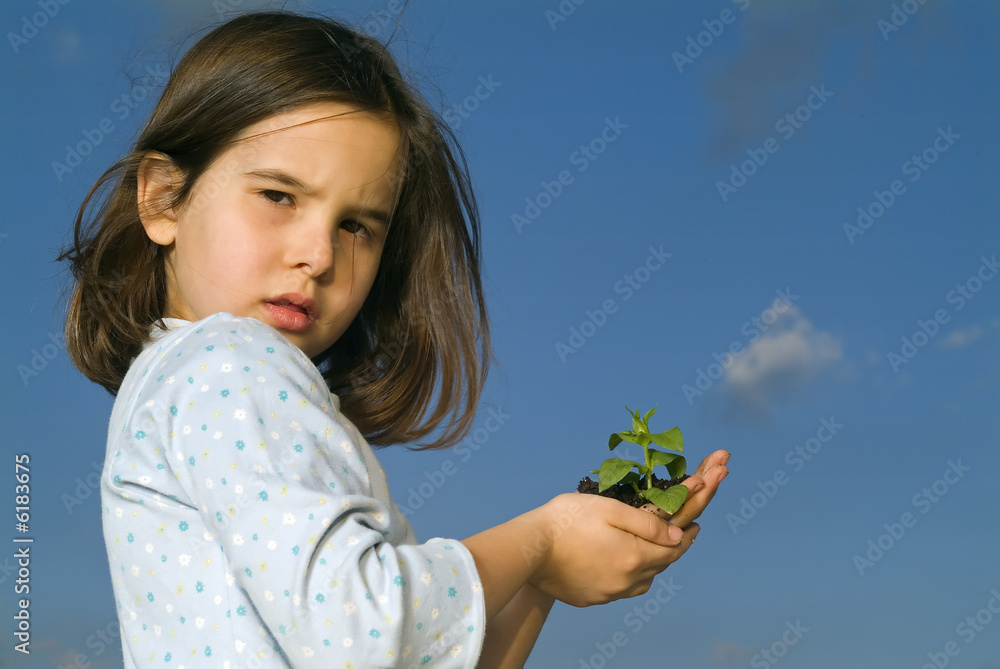 girl holding plant against blue sky with a cloud girl holding plant against blue sky with a cloud