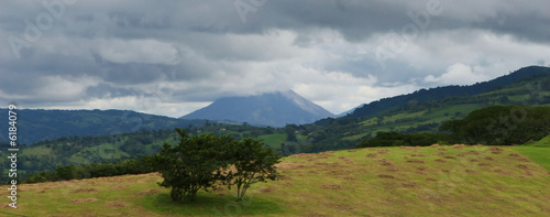 An active volcano in Costa Rica loom in the stormy background