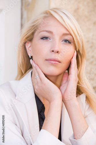 Portrait of young woman holding her cheeks