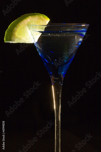 Cocktails, drinks, and alcohol in a colored glass at a bar photo