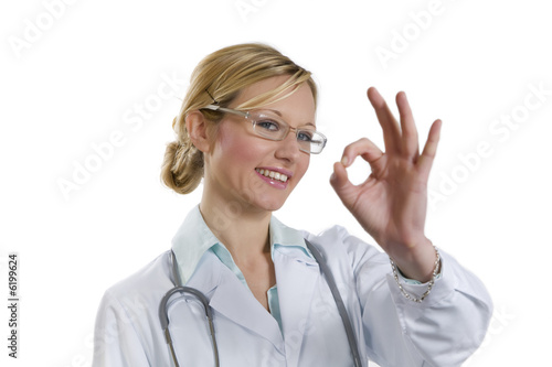 healthcare and medicine: young doctor doing ok gesture