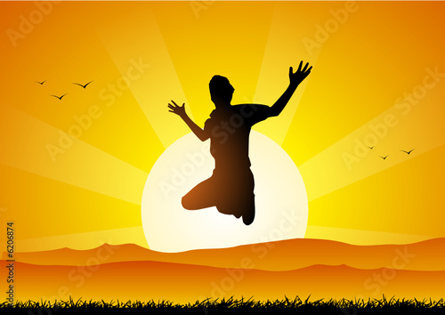 Happy boy jumping at sunset