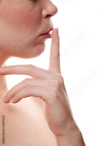 beautiful woman posing with her finger on her lips