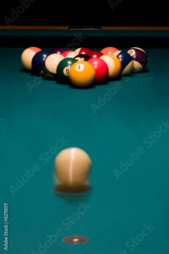 White ball is rolling to break the racked billiard balls