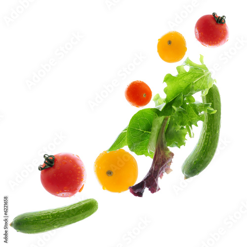 Assorted fresh vegetables flying isolated on white background