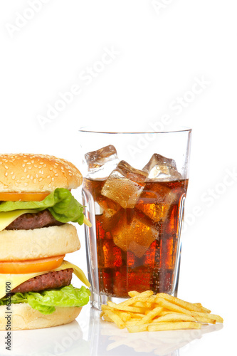 Hamburger and soda, reflected on white background. Shallow DOF