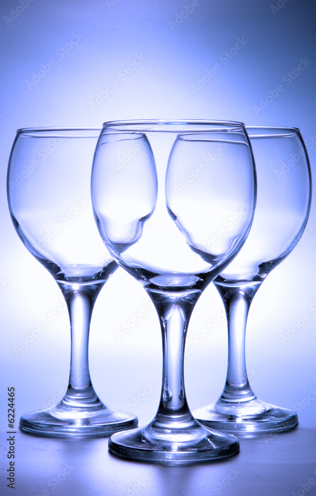 Three empty footed glasses toned in blue color Three empty footed glasses toned in blue color