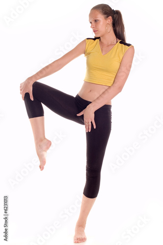A young girl doing fitness exercise on white