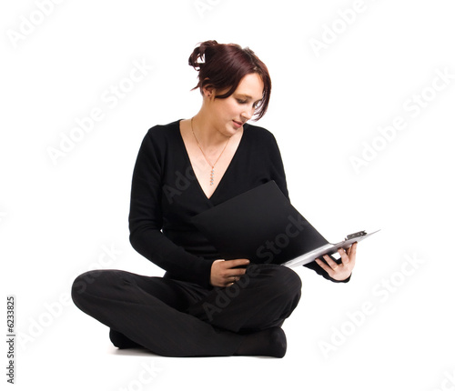 Young teacher with document case in yoga lotus pose.