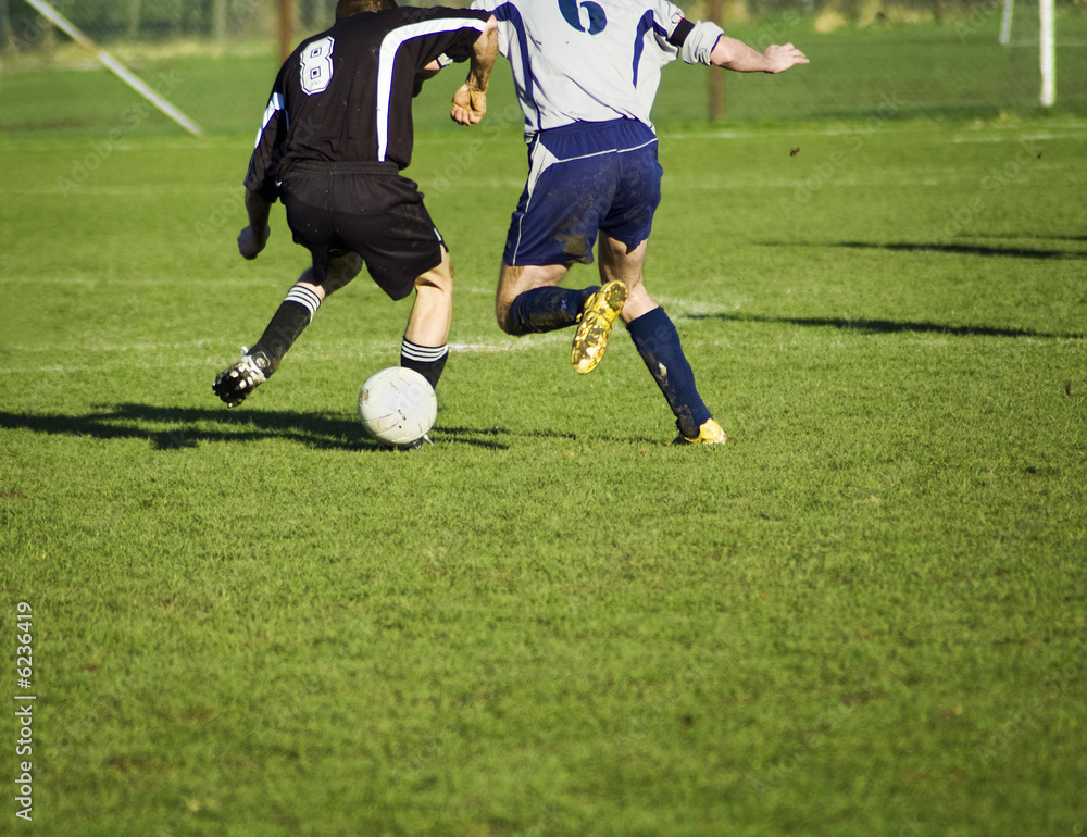 soccer players in action. in duel for the bal.