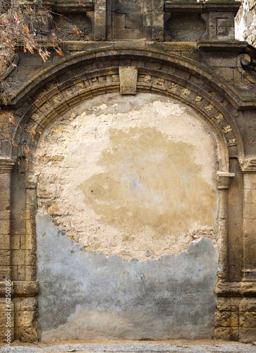 Ancient immured arch within old shell rock wall