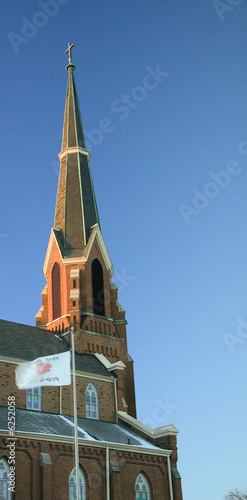 a church steeple sits high in the morning sky