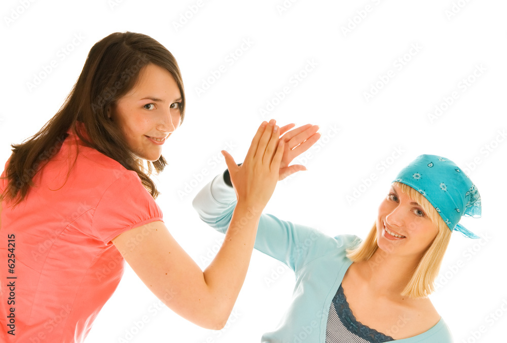Two teenagers giving high five isolated on white background Two teenagers giving high five isolated on white background