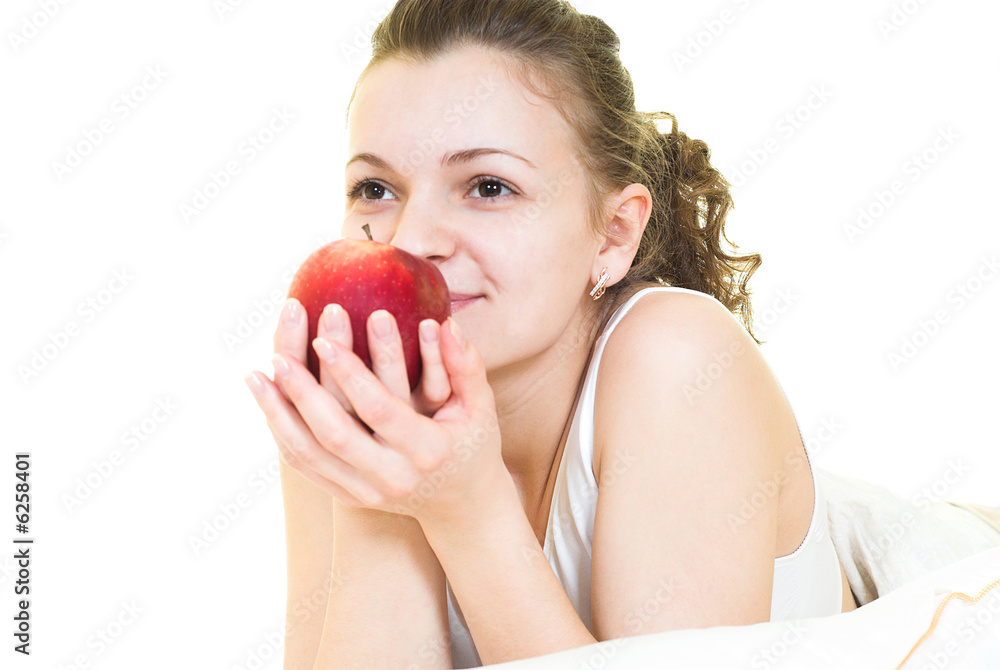 Young girl is dreaming and smelling apple. Isolated. Young girl is dreaming and smelling apple. Isolated.