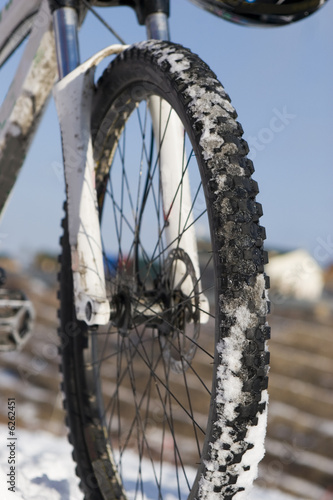 Bike in winter mountains over blue sky
