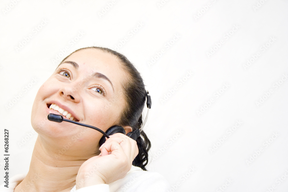 Happy young woman on headset telephone smiling Happy young woman on headset telephone smiling