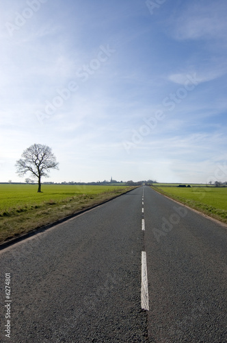 Long road with white lines stretching out to the vanishing point