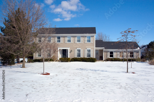 Colonial House with snow in the front yard