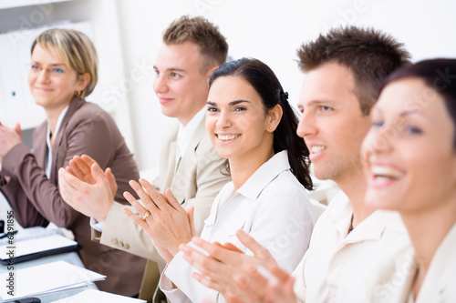 Clapping business people