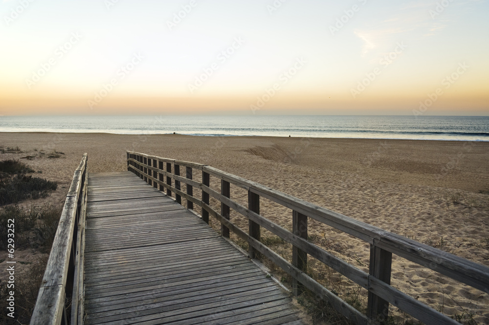 Wooden footbridge leading to the empty beach