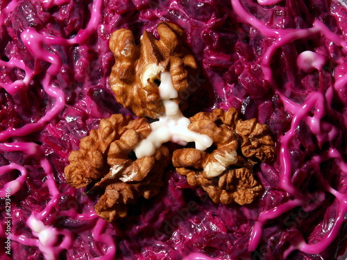 Walnut on red beet salad