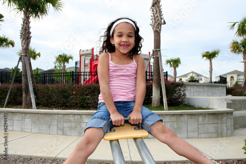 Young girl outside playing ...