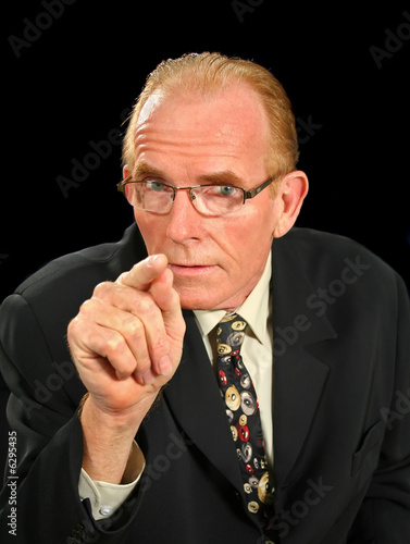 Fotografia Middle aged businessman pointing in an intimidating manner.