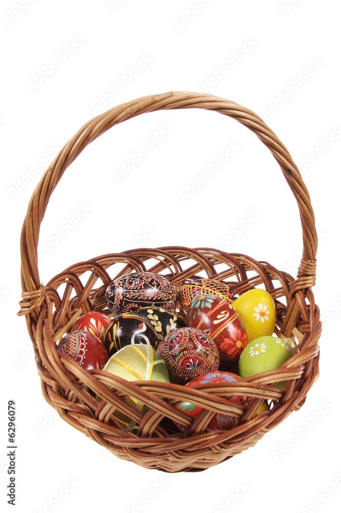 The basket with Easter eggs isolated on white background