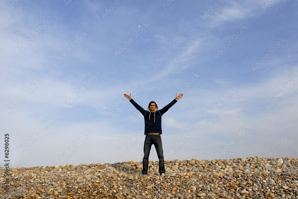 man with arms wide open at the beach man with arms wide open at the beach