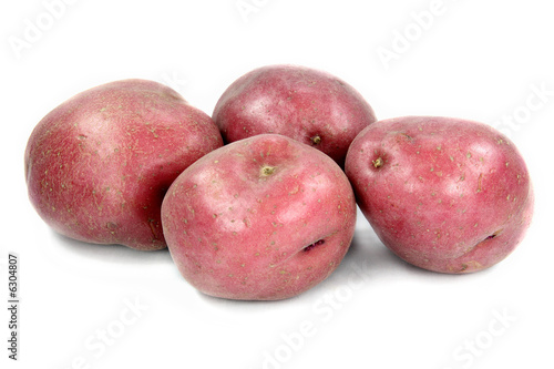 Tubers of red potatoes over white background.