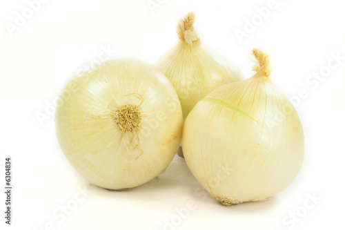 Bulbs of white sweet onion over white background.