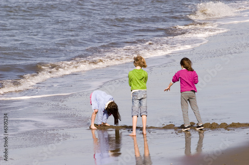 Three girls playing on the beach