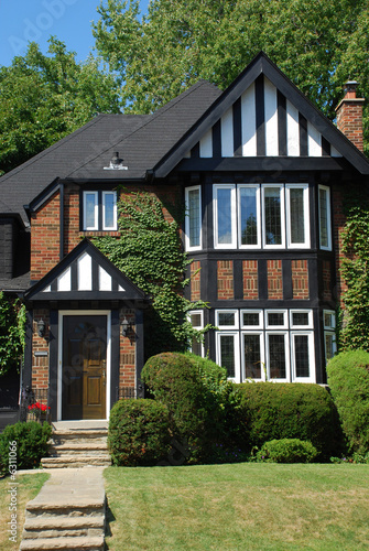 small tudor style house with black and white trim