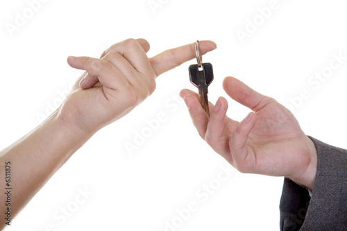 Man s hand with key isolated at the white background