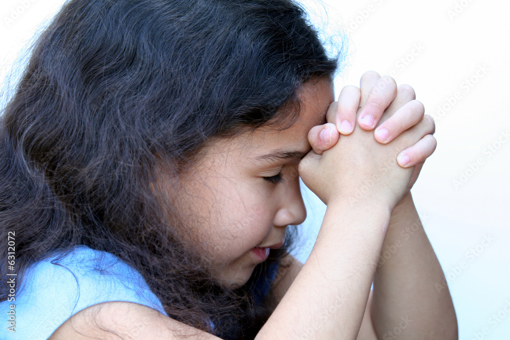 Young girl on white background who is thinking or praying Young girl on white background who is thinking or praying